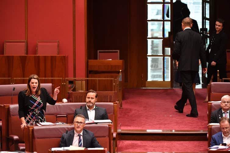 Greens Senator Sarah Hanson-Young speaks during a censure motion against Independent Senator Fraser Anning (on right) as he walks out of the Senate chamber.