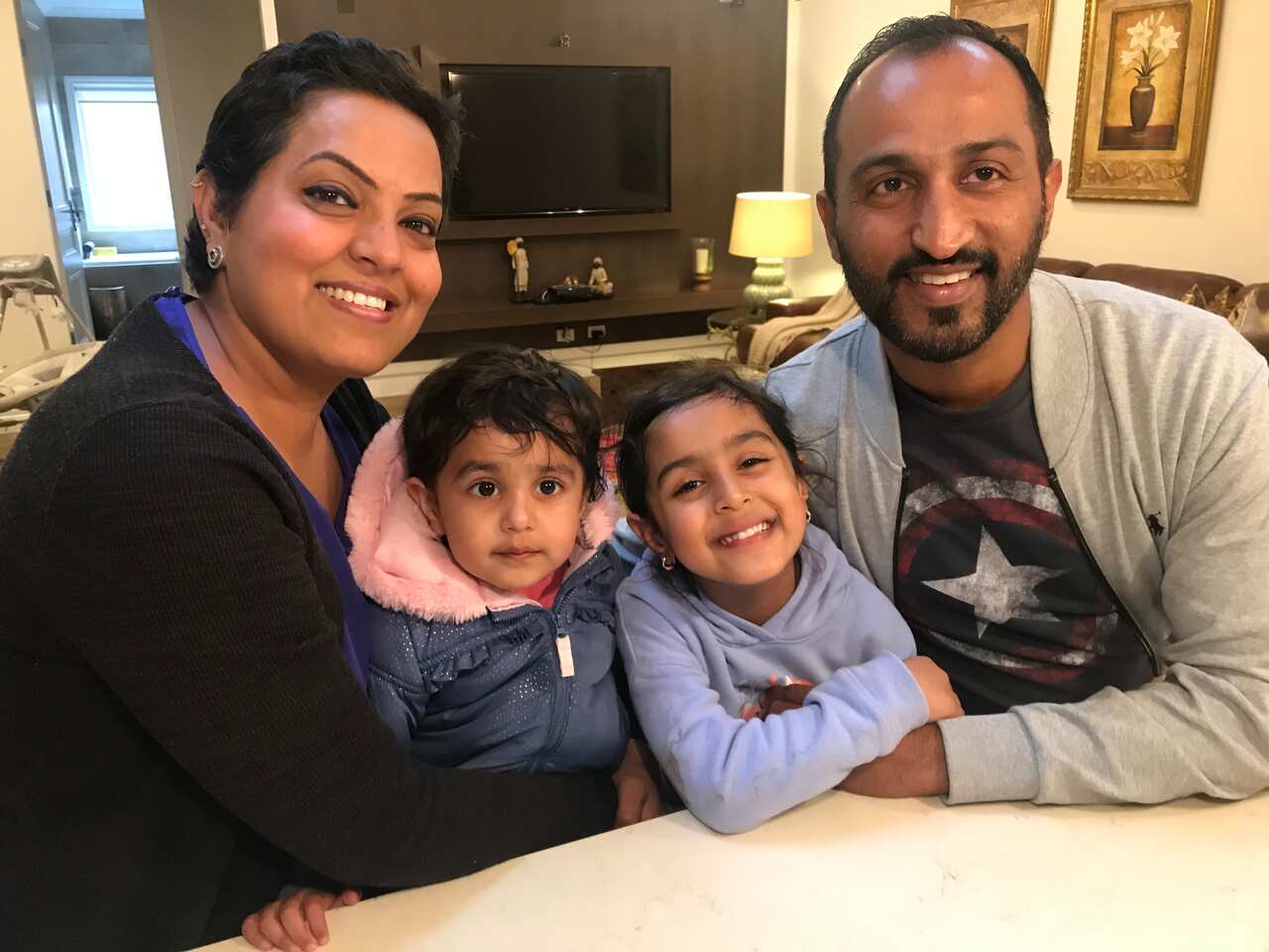 Inderdeep and Harpreet Sandhu with their two children.  
