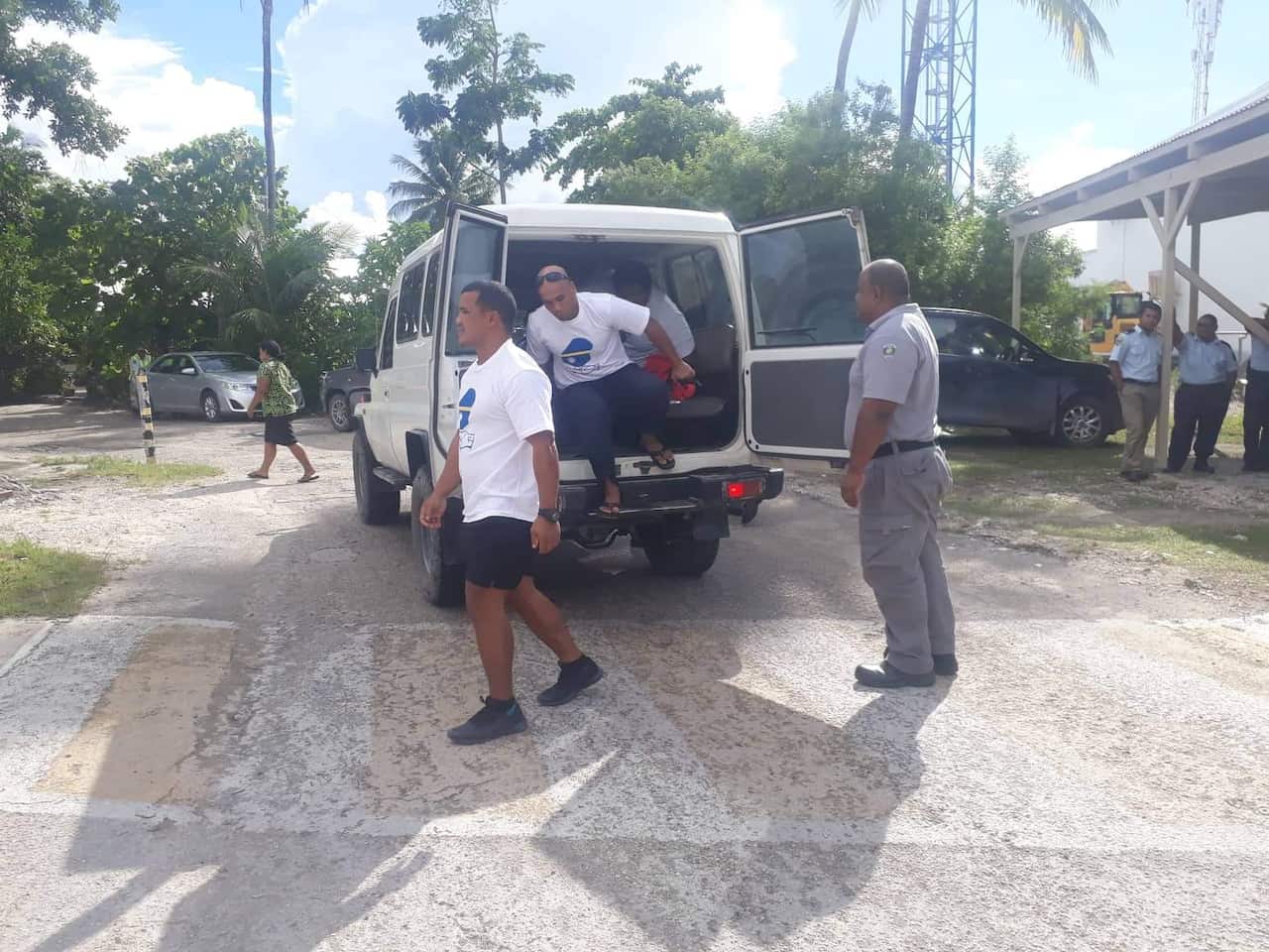The defendants head into court under police guard.
