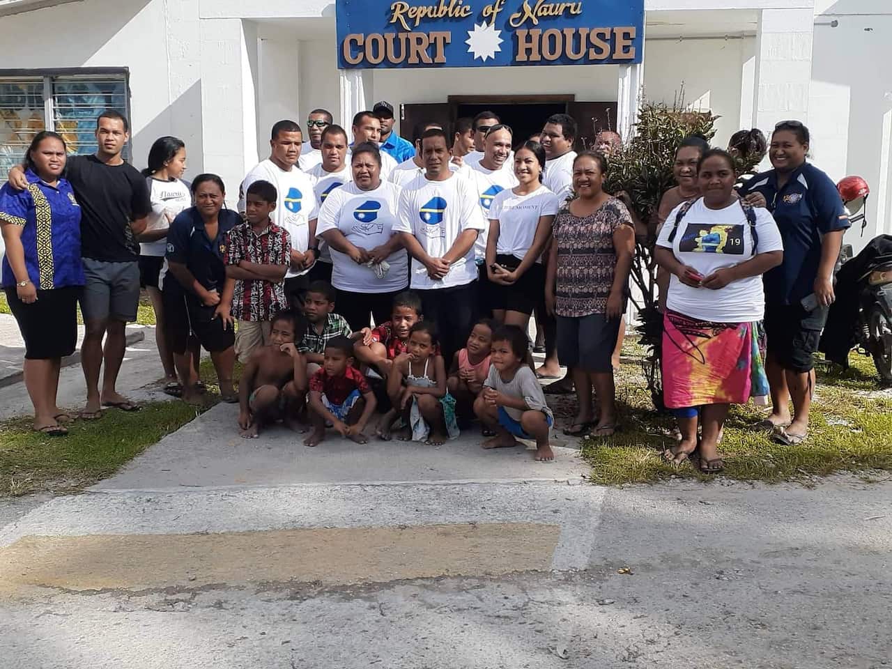 The Nauru 15 pose outside the court house, ahead of the decision.