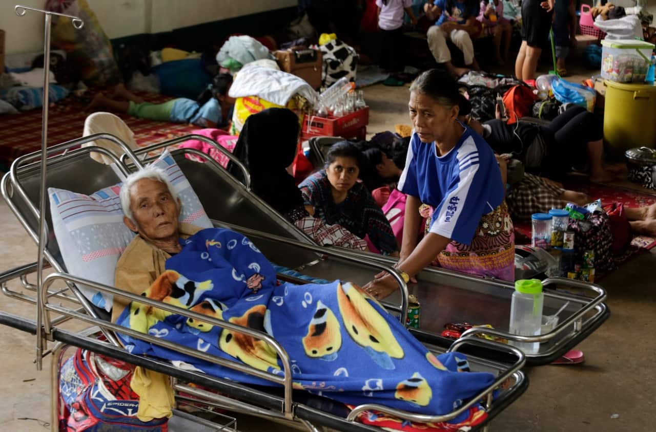 Filipino elderly who were displaced due to fighting between government soldiers and Muslim rebels rest inside a temporary evacuation center (AAP)