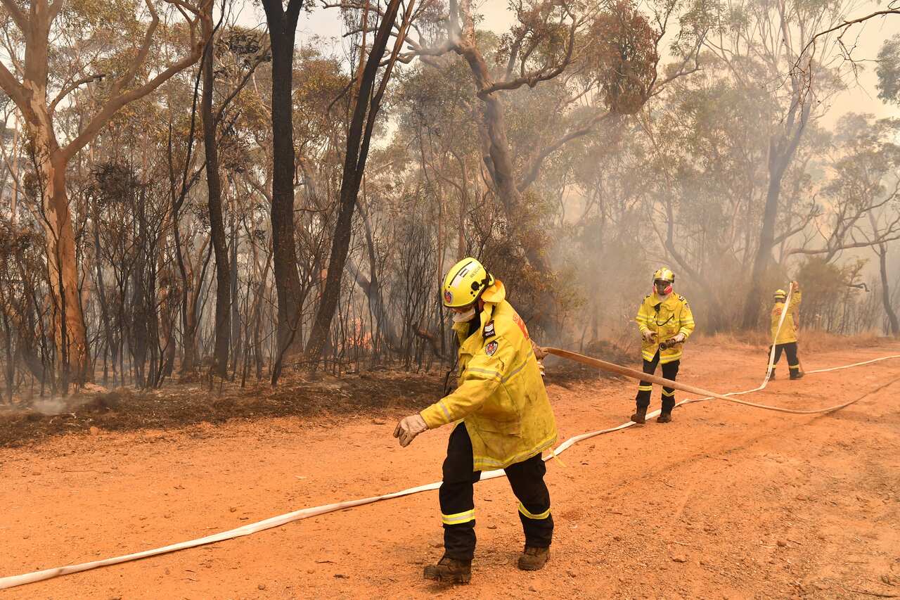 New South Wales Rural Fire Service (RFS) and Fire and Rescue NSW (FRNSW) battle the Gospers Mountain fire.