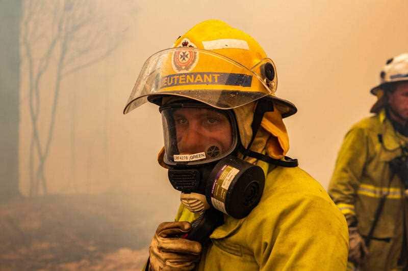 A firefighter looks on as crews battle a blaze outside Deepwater.