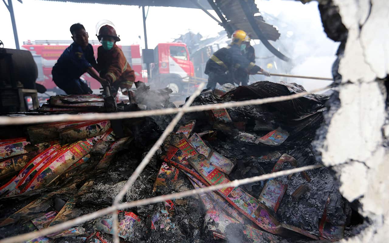Firefighters work at the site of an explosion at a firecracker factory in Tangerang, on the outskirts of Jakarta.