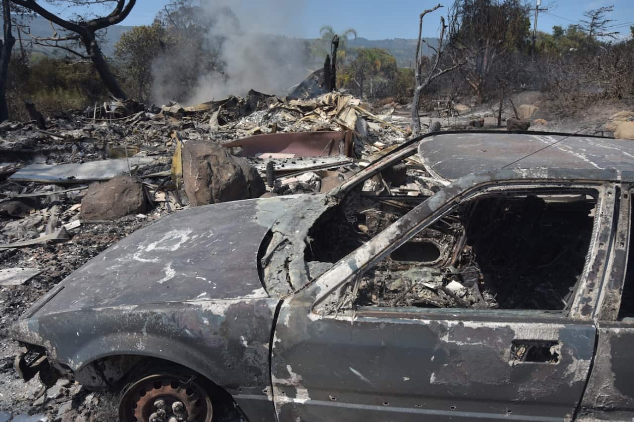 Smoke rises from the remains of a destroyed home in the aftermath of the Holiday Fire on July 7, 2018 in Goleta, California.