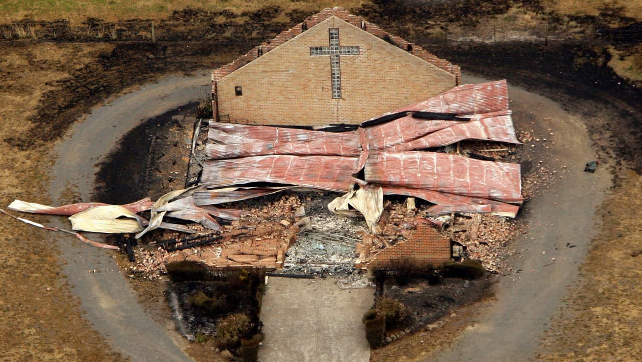 One wall stands above the rubble of a destroyed church at Kinglake northeast of Melbourne on Sunday, 8 February 2009.