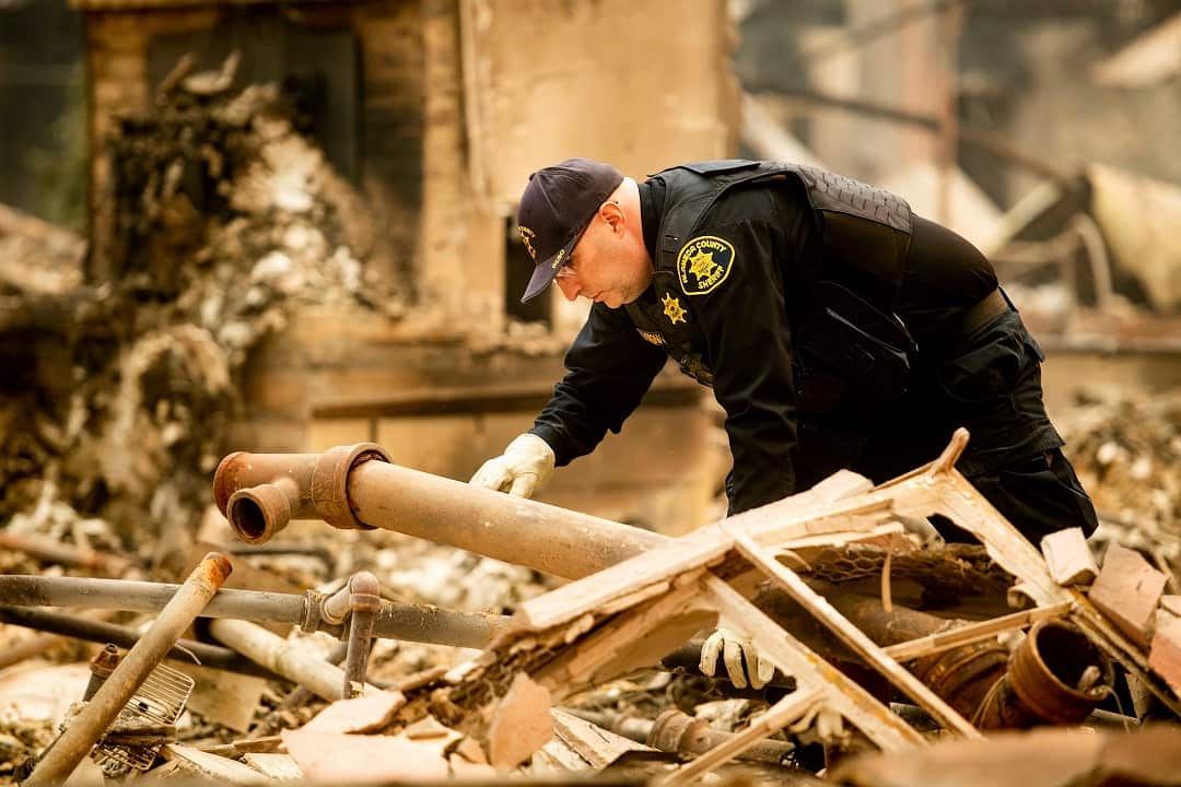 Alameda County Sheriff's deputy A. Gogna searches for victims of the Camp Fire on Monday, Nov. 12, 2018. (AP Photo/Noah Berger)