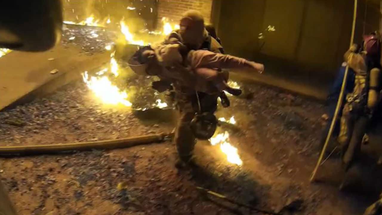 Captain Scott Stroup saves a child from the fire.