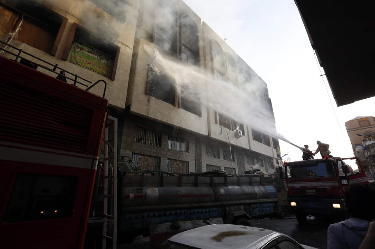 Firefighters work to extinguish a fire near the residence of Yemeni ex-president Ali Abdullah Saleh (AAP)