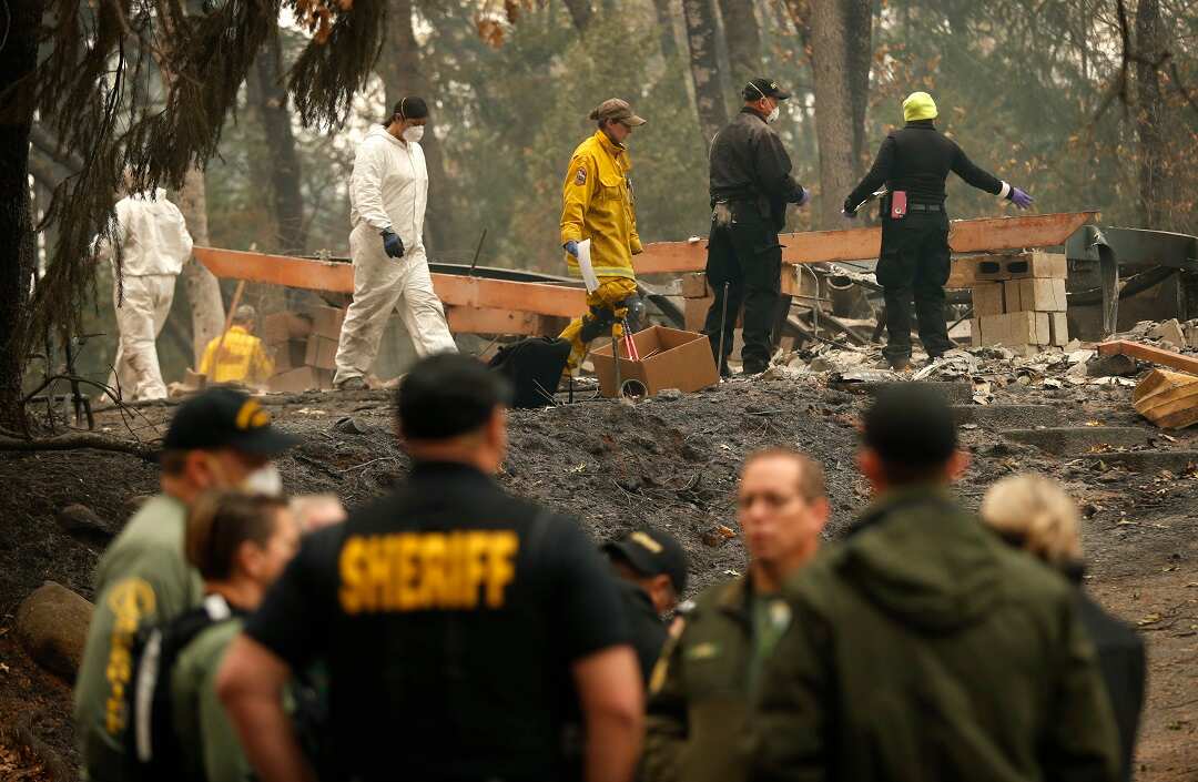 Investigators recover human remains at a home burned in the Camp fire.