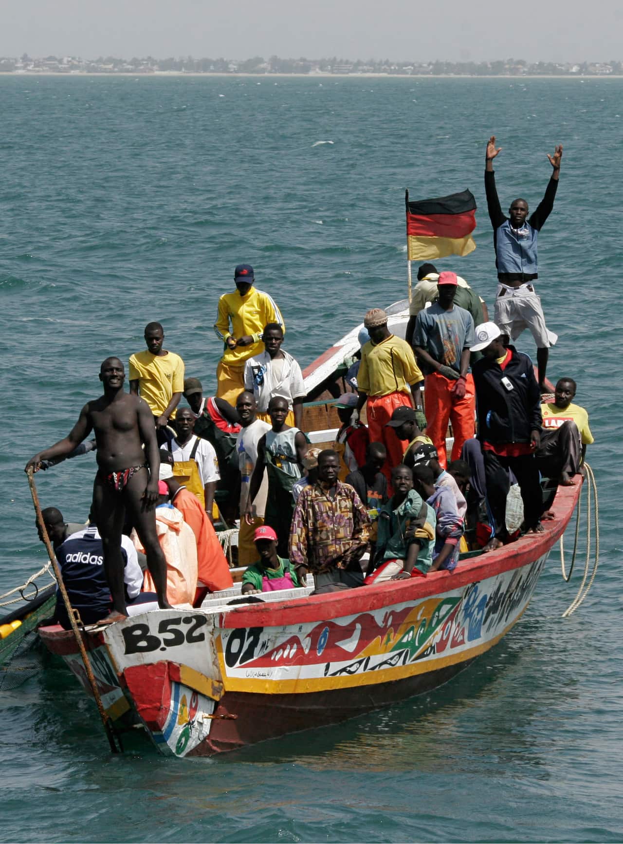 Fishermen wave to a Spanish patrol boat looking for would-be migrants, off the coast of Senegal. Thousands of fishermen have disappeared in the region.