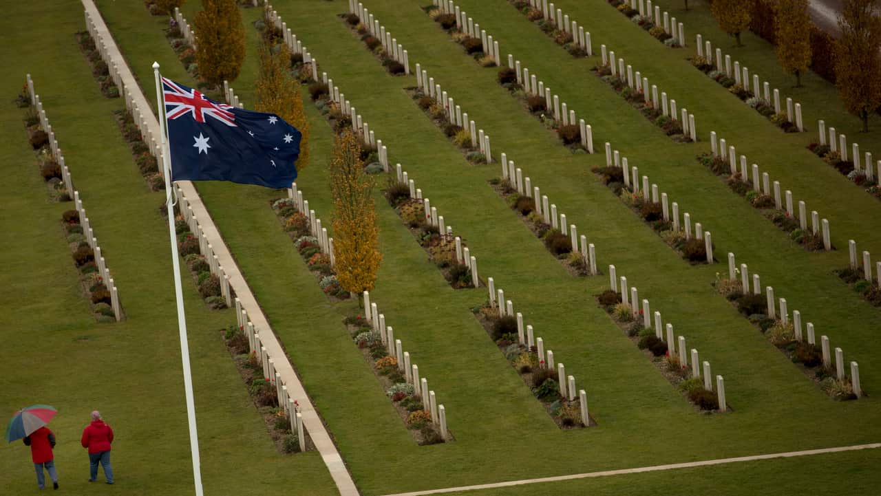 Two visitors walk among the headstones at the World War I Australian National Memorial in Villers-Bretonneux, France.