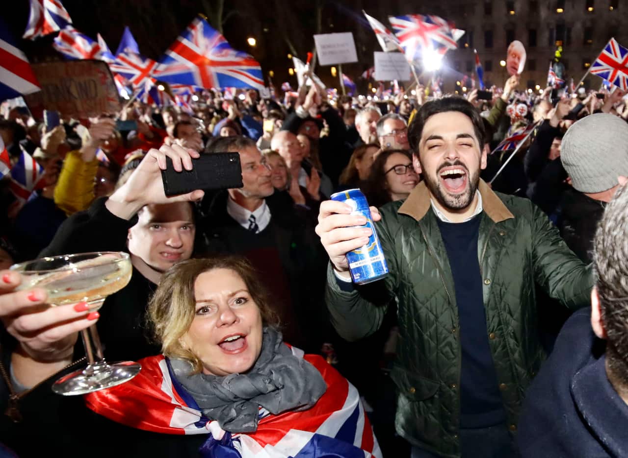 People celebrate near the Houses of Parliament in London as the United Kingdom leaves the European Union.