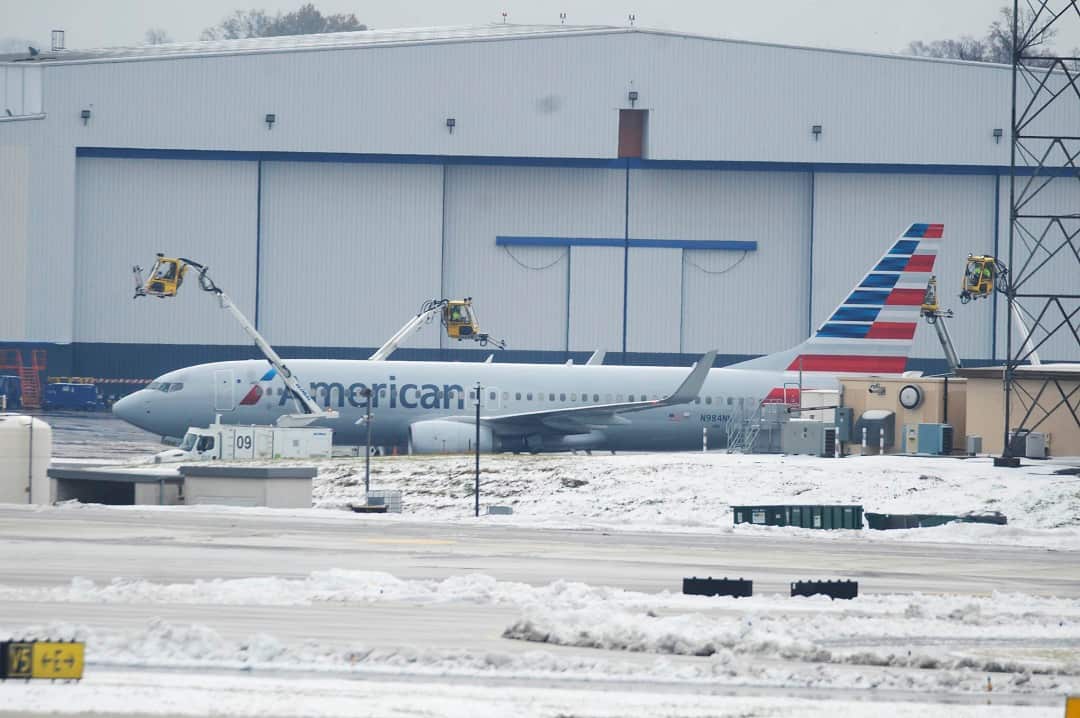 Crews move equipment into position to de-ice airplanes at Charlotte Douglas International Airport.