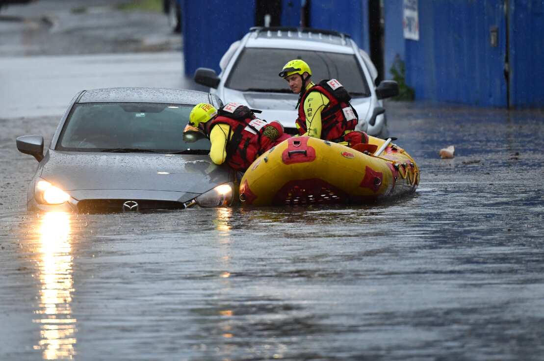 A search team is seen with flooded cars on Longlands Street at Woolloongabba in Brisbane, Tuesday, October 27, 2020.