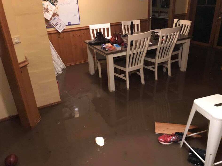 Photo shows a kitchen flooded in a Hobart suburb.