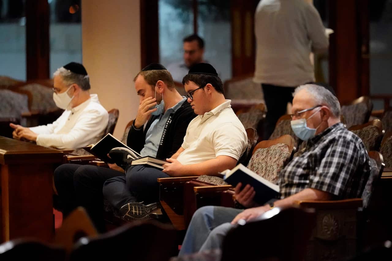 Jewish faithful pray at the Shul of Bal Harbour after members of the community were reported missing in the partial collapse of a beachfront condo.