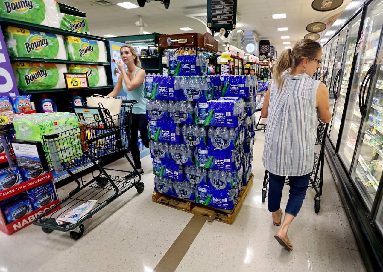 People shop at the Harris Teeter, filling up on water and supplies as Hurricane Florence becomes a threat to the coast Monday, Sept. 10
