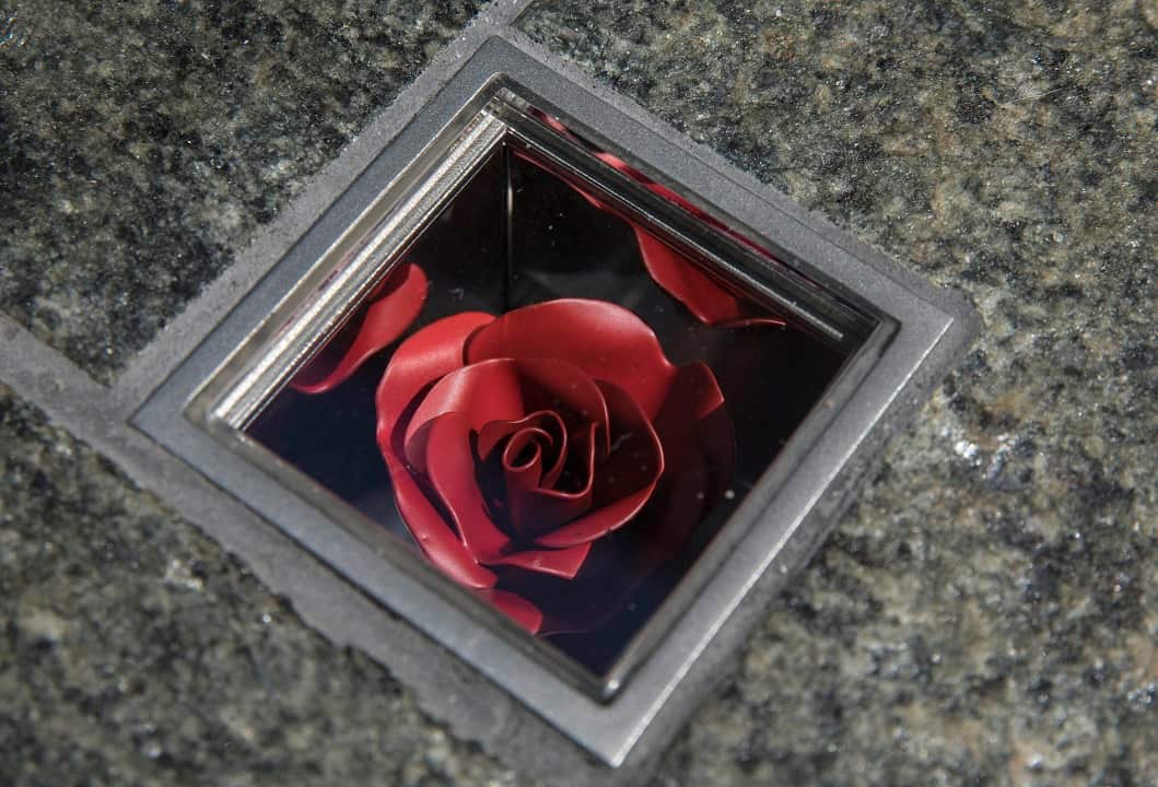 The permanent memorial to the Sydney siege victims  comprises of 210 individual boxes with flowers embedded in the granite pavement.
