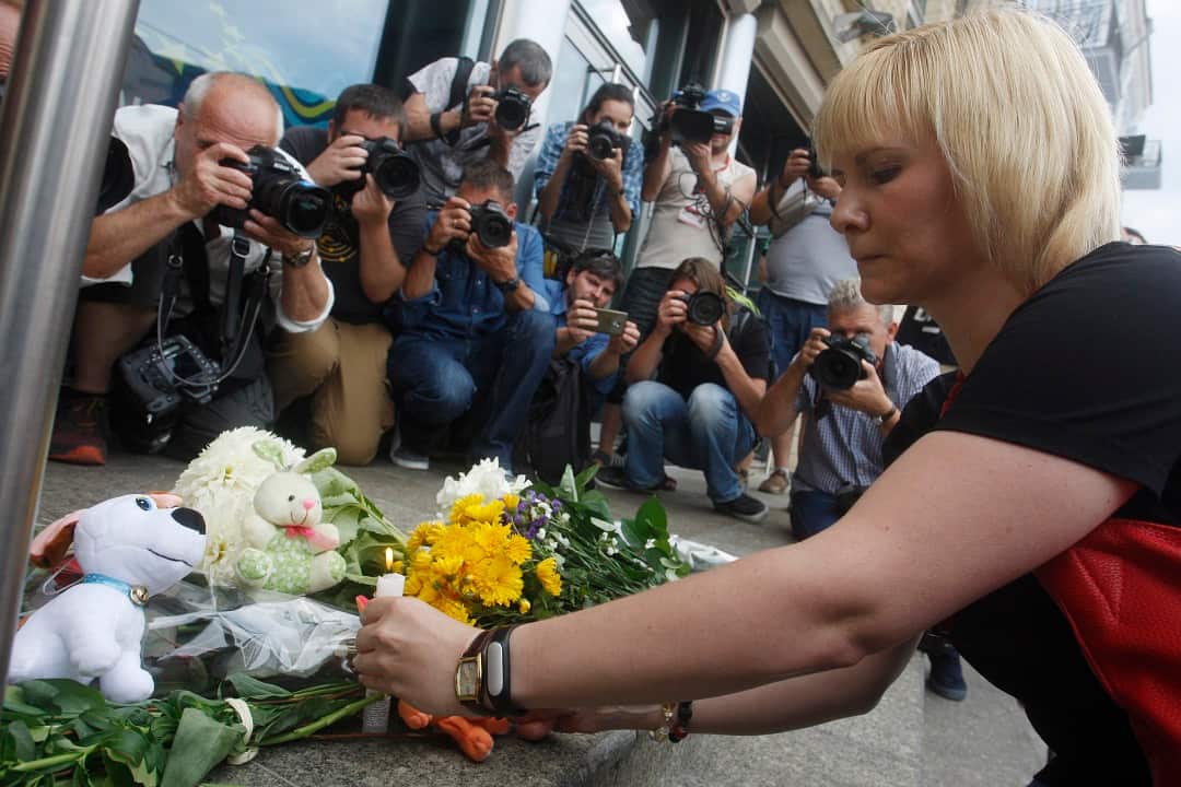 People place flowers in front the Dutch embassy in Kiev, Ukraine.