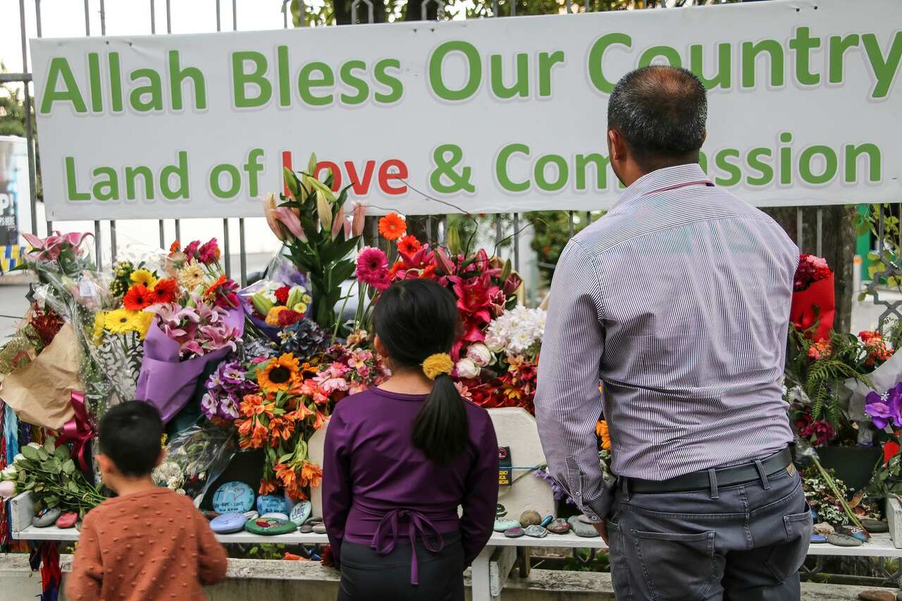 New Zealanders place flowers outside the Al-Noor Mosque on second anniversary of the 2019 attacks. 