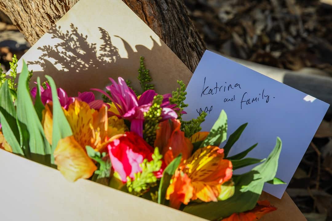 Flowers are left next to a police roadblock where police are investigating the death of seven people in suspected murder-suicide in Osmington.