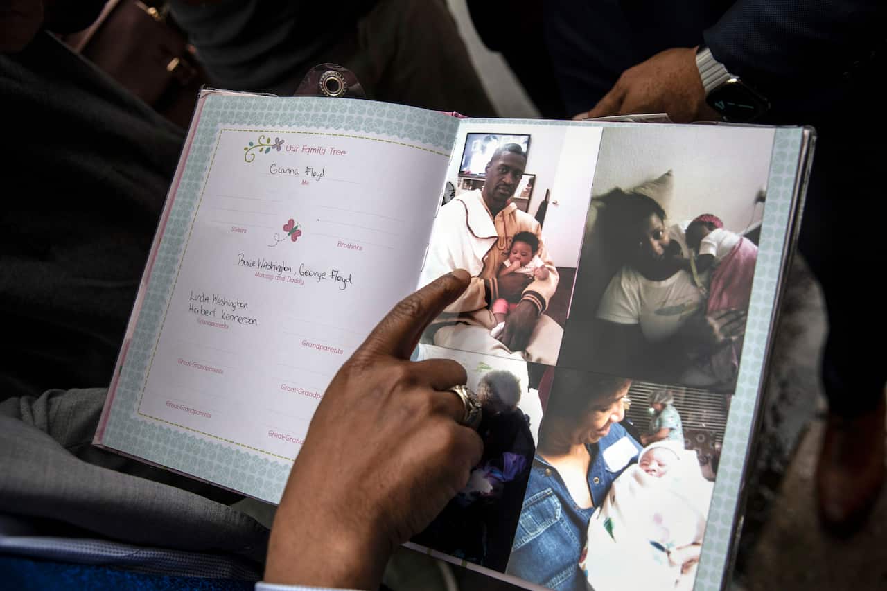 A photo of George Floyd in a baby book made to commemorate the birth of his daughter, Giana Floyd, in Minneapolis on June 2, 2020.  (Victor J. Blue/The New York Times)