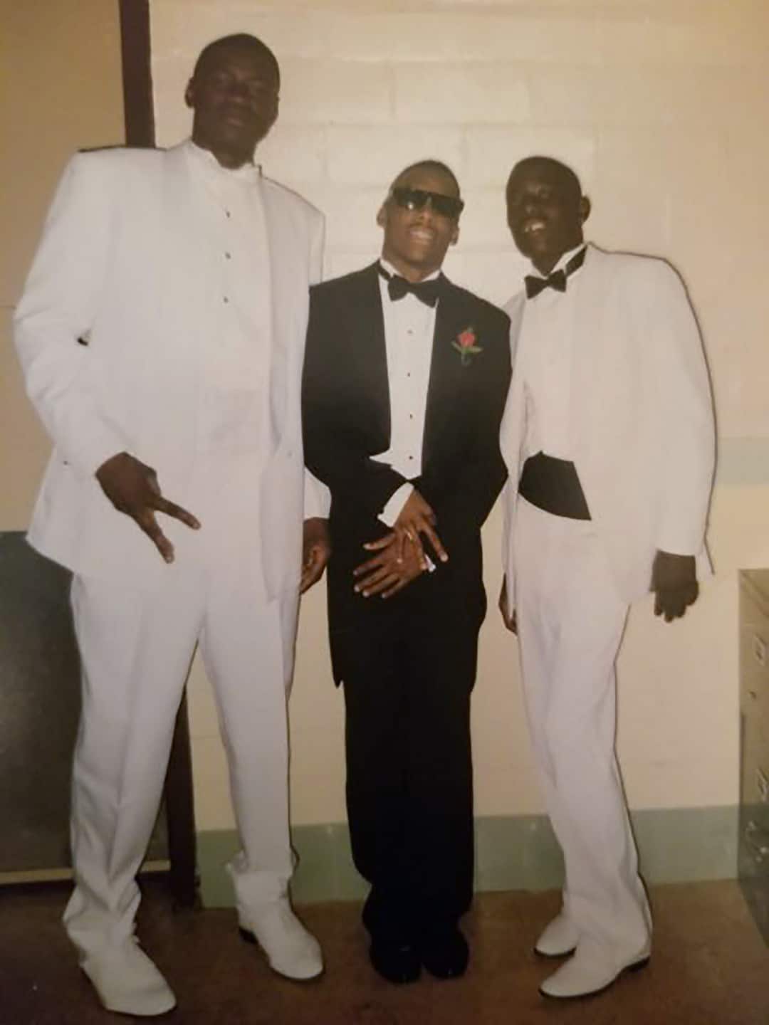 A handout photo shows George Floyd, left, standing with Jonathan Veal and Milton Carney at a high school dance in 1993. (via The New York Times)