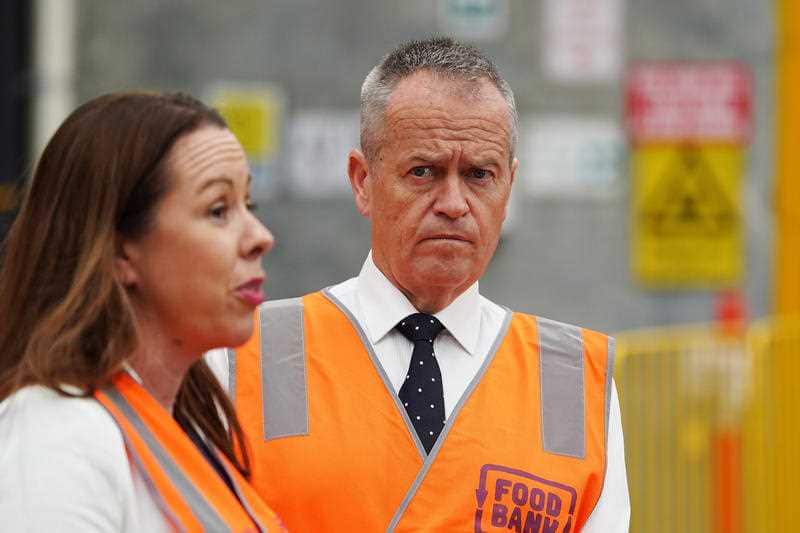 Federal Opposition Leader Bill Shorten looks on as Foodbank CEO Brianna Casey.