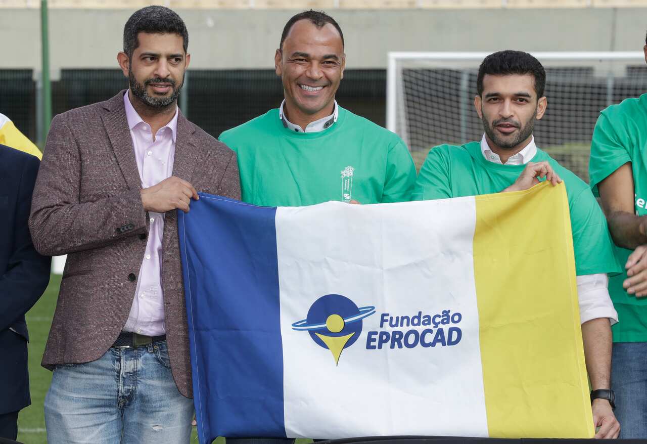 Former Brazilian soccer player Cafu, center, poses  with FIFA World Cup Qatar 2022 chair Hassan Al Thawadi, left, and Nasser Al-Khater.