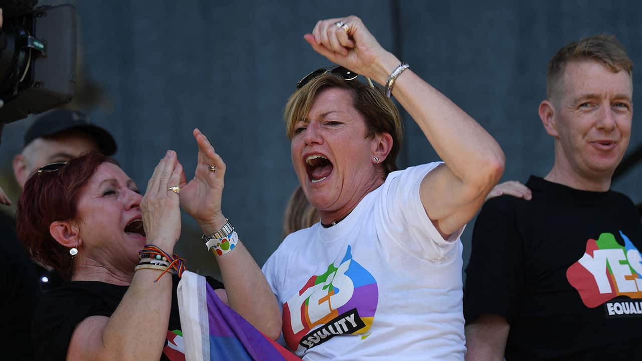 Christine Forster, the sister of former Prime Minister Tony Abbott, celebrates after watching the same sex marriage vote result announcement.