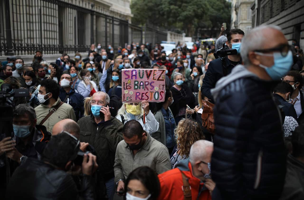 Angry restaurant and bar owners demonstrate, one with a placard reading "Save cafes and restaurants" in Marseille, southern France.