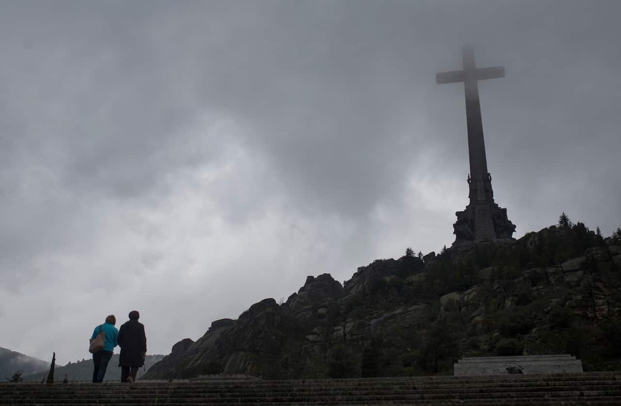 Tourists walk outside of the Spanish former dictator General Francisco Franco's tomb at the Valle de los Caidos (Valley of the Fallen), near Madrid