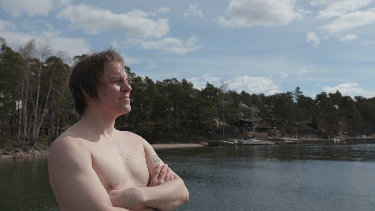 Frank Martela happiness expert enjoying an icy dip in the sea. 