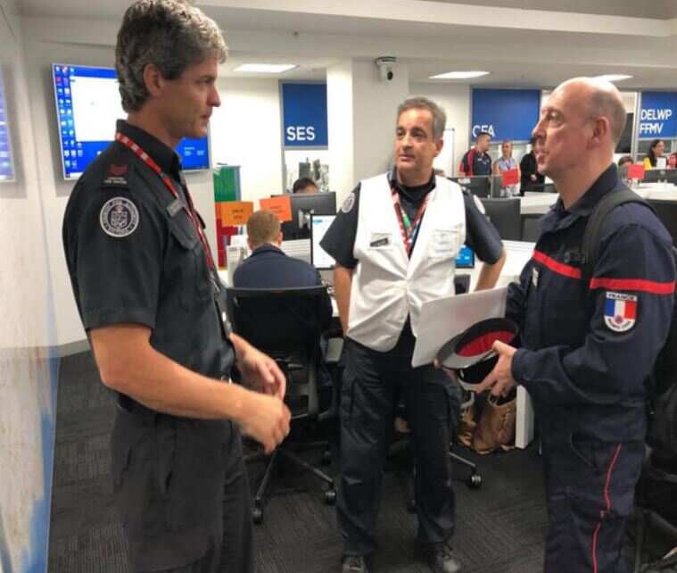 French Team Leader Bruno Ulliac (right) speaking with NSW Rural Fire Service officers. 