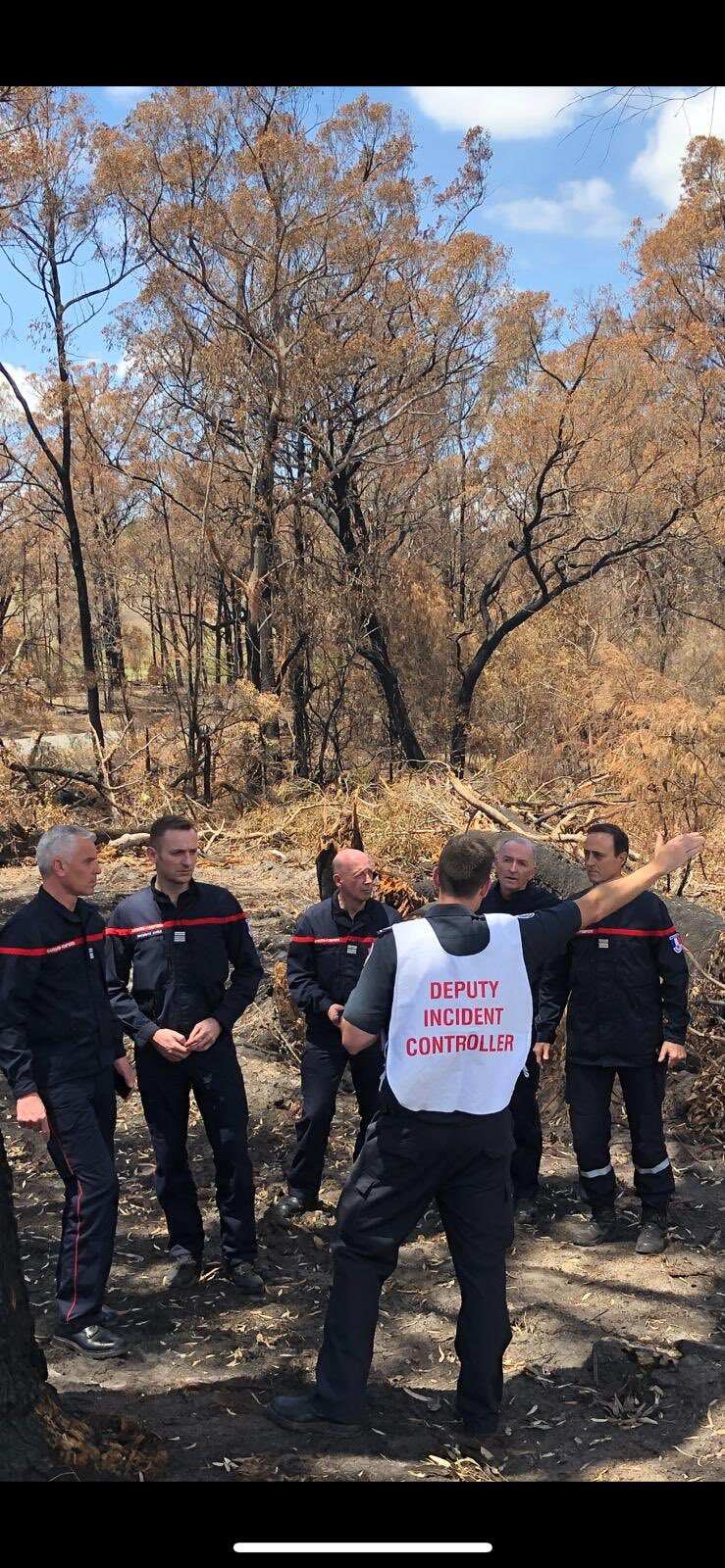 French firefighters get a briefing in Victoria. 