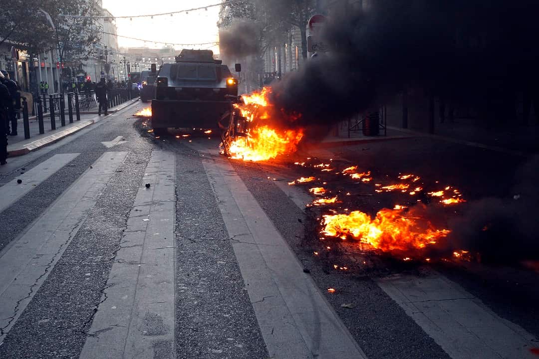 Police armored vehicles were brought in as "yellow vest" protests set cars on fire.