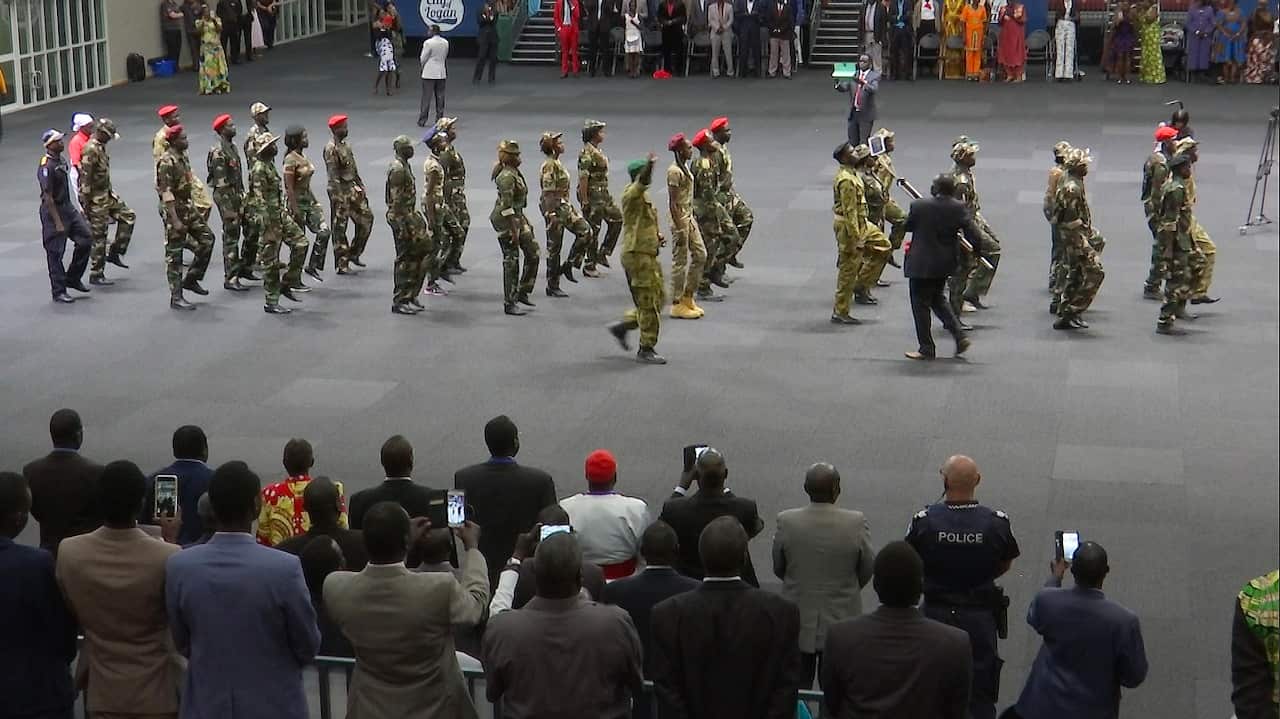 Two dozen men and women in makeshift uniforms marched in military formation for a crowd of several hundreds fellow South Sudanese.