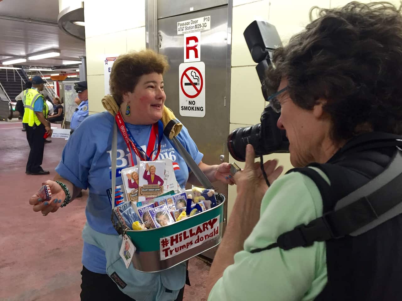 A woman takes Lori's photo on a subway platform