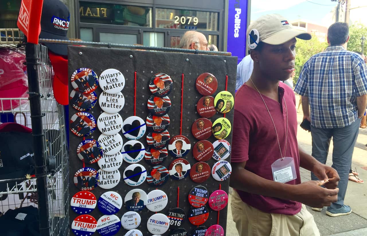 A man sells pro-Trump badges.