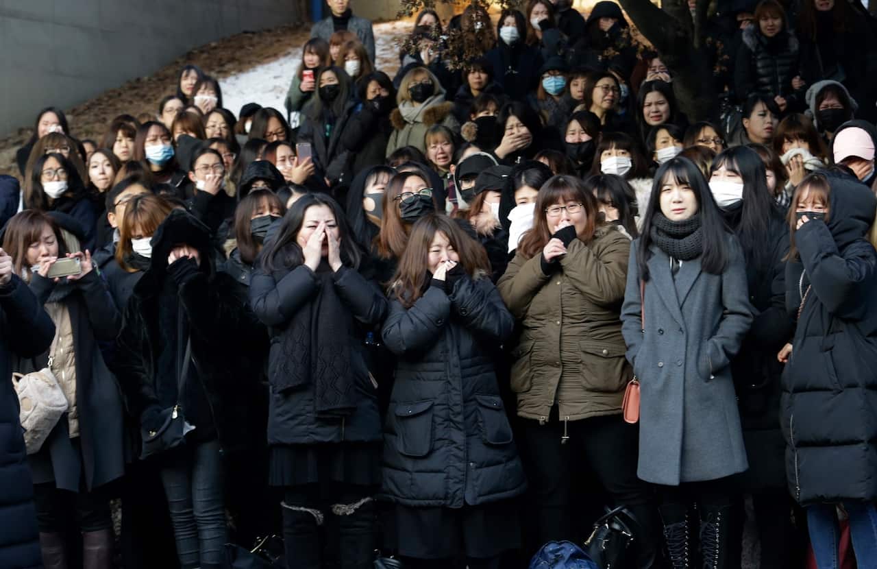 Fans of late South Korean singer Kim Jong-hyun react during his funeral On December 21