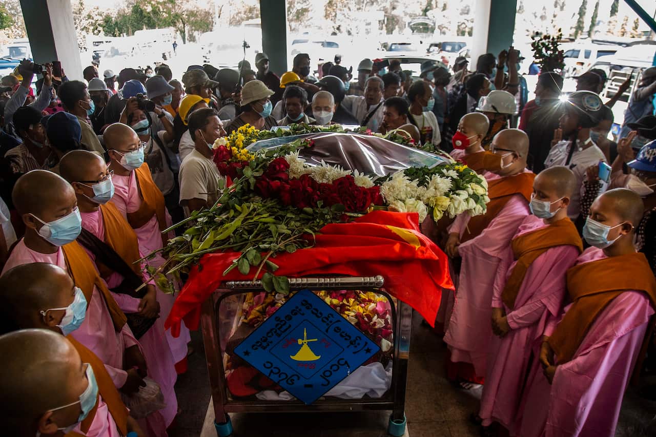 Buddhist nuns surround the casket of Pho Chit, an anti-coup protester who died during a March 3 rally.