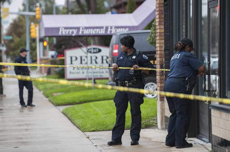 Detroit Police officers use crime scene tape to cordon off Perry Funeral Home.