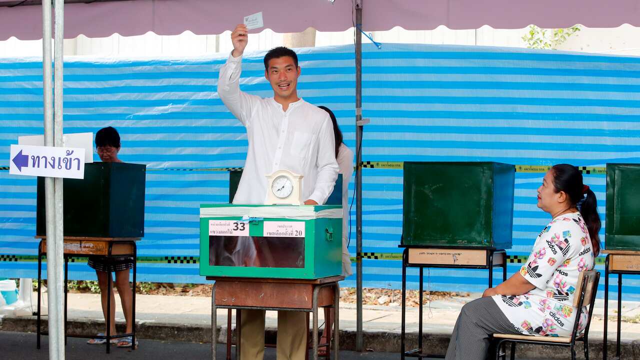 Thai Future Forward Party co-founder and leader Thanathorn Juangroongruangkit (C) casts his ballot at a polling station during the general election in Bangkok.