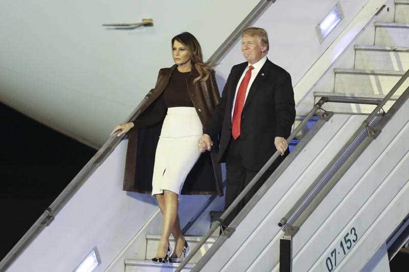 President Donald Trump and first lady Melania Trump walk from Air Force One.