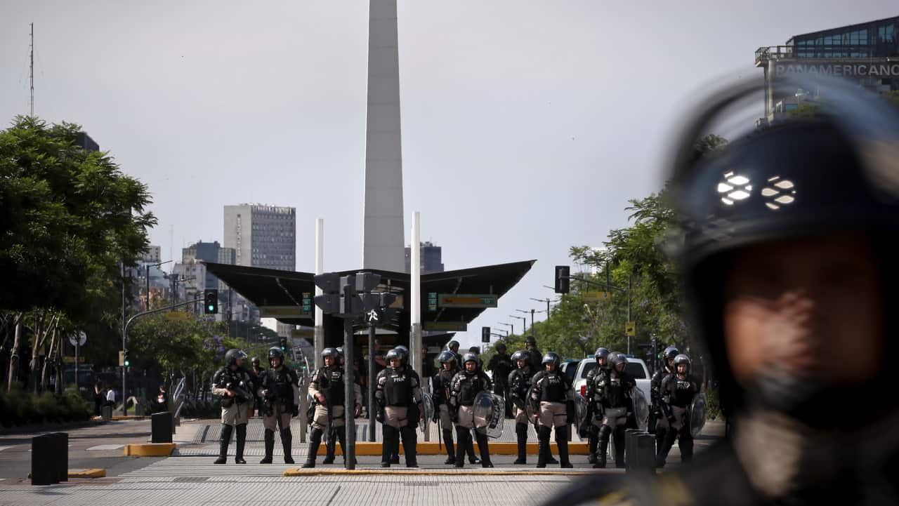 Federal law enforcement officers of the Argentine Naval Prefecture (PNA) monitor a protest against the G20 Summit, in Buenos Aires.