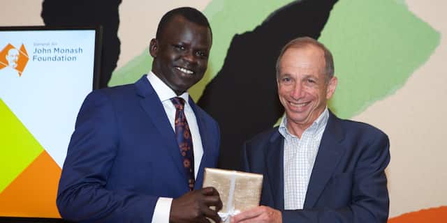 Dr Garang Dut receiving a scholorship. 