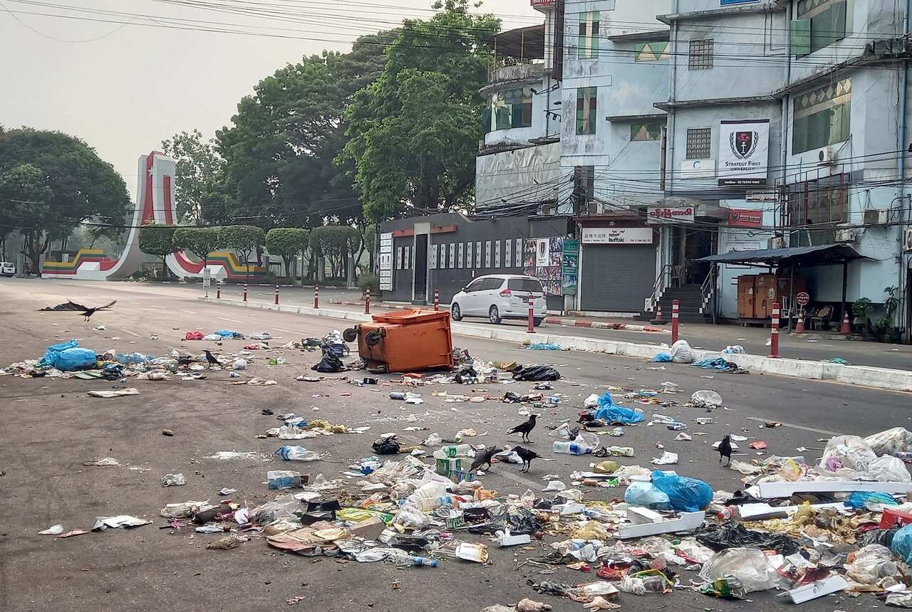 Protesters throw the garbage on the road as a protest against the military coup in Yangon, Myanmar, 30 March 2021.  