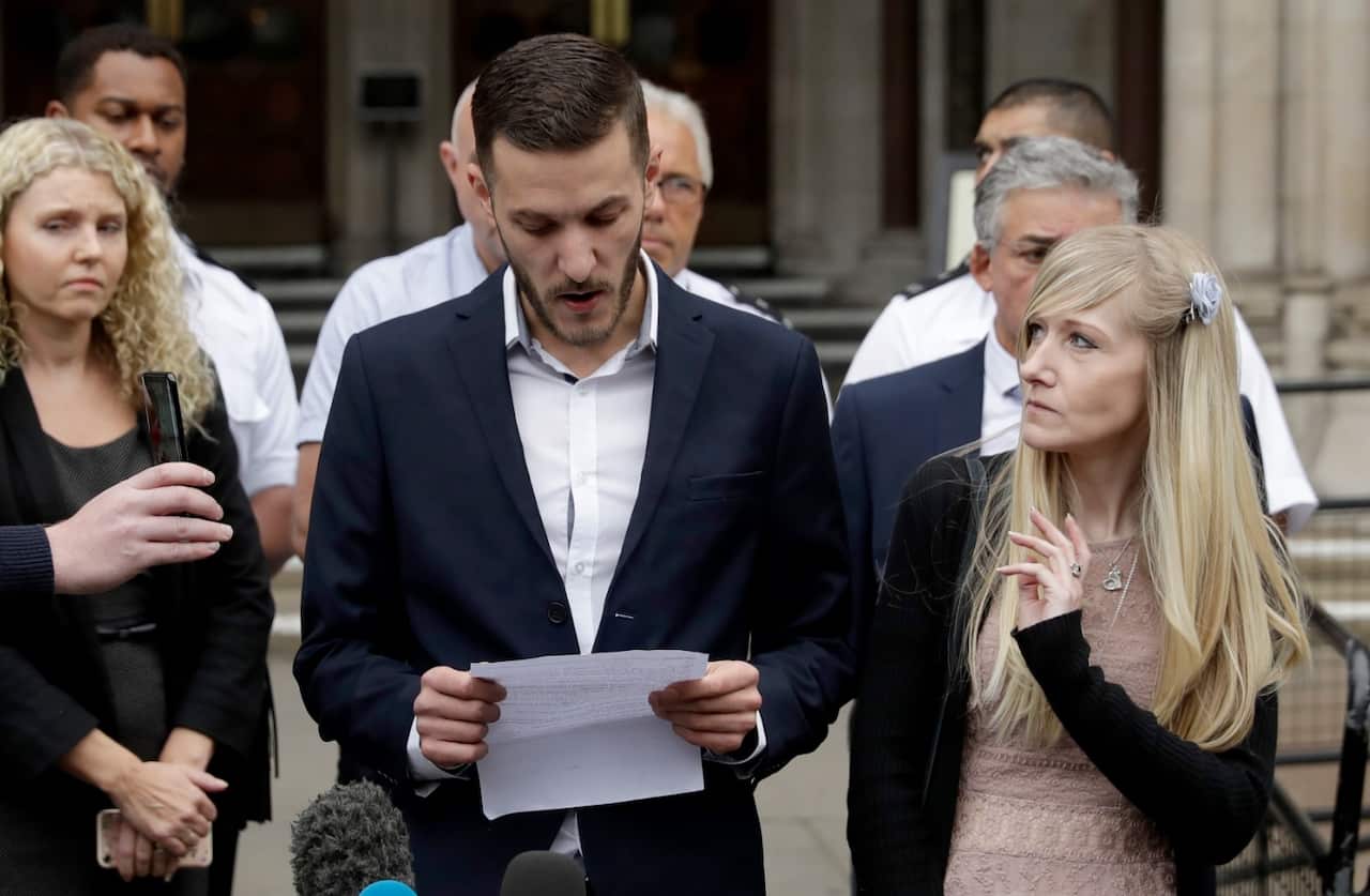 Chris Gard,the father of critically ill baby Charlie Gard reads out a statement with mother Connie Yates, right on July 24 (AAP)