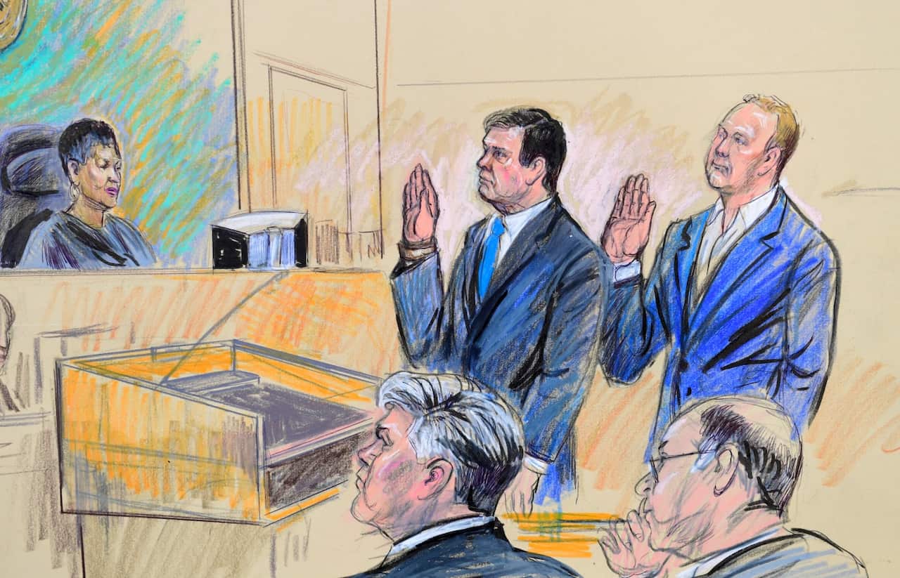 A court artist drawing shows President Donald Trump's former campaign chairman, Paul Manafort, center standing and Manafort's business associate, Rick Gates